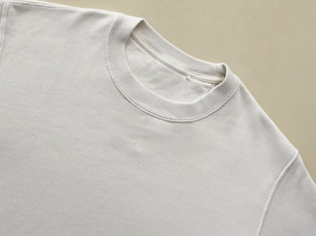 Thick cream fabric with ribbed collar — weight, drape, and structure up close